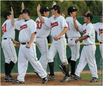 CSUEB Pioneer baseball team high-fiving each other