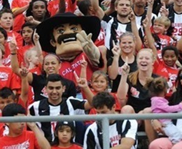 youth soccer players with CSUEB Pioneer Pete in University's stadium.