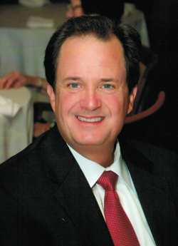 headshot of Robert Schumacher in suit and tie