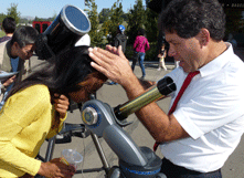 Gary Weston, associate professor of physics, adjusts telescope for interested student. (By: Barry Zepel)